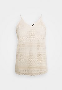 Lace camisole in light beige with a V-neck, adjustable straps, and intricate patterned texture, featuring scalloped hem and open weave details.