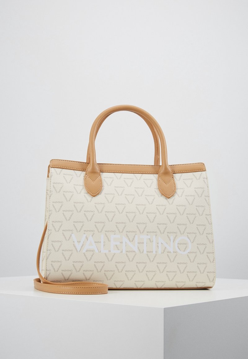 Beige handbag with tan leather accents, featuring a repeating logo pattern and a large white "VALENTINO" text. Includes a detachable shoulder strap.