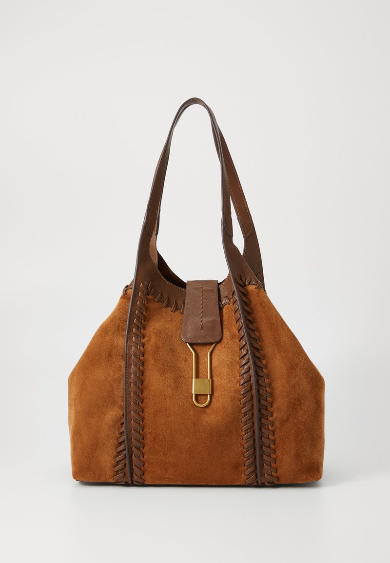 Brown suede tote bag with dark leather trim, decorative stitching, and a gold-tone clasp on a front strap closure.