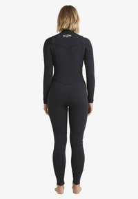 Black wetsuit with long sleeves and full legs, featuring a fitted design and seamless construction. Logo on the back neck area.