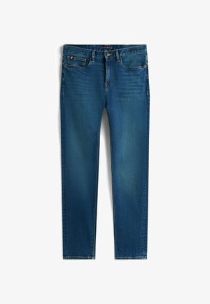 Dunkelblaue Slim-Fit-Jeans mit fünf Taschen und Knopfverschluss, mit dezentem Verblassen an den Oberschenkeln und einem kleinen Flaggenetikett an der Münztasche.