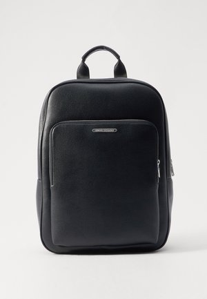 Black leather backpack with a textured finish, front zip pocket, and top handle. Features a silver logo detail and smooth zipper accents.