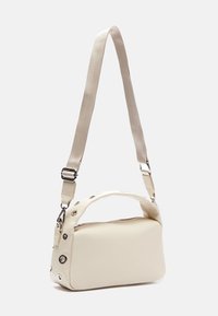 Beige crossbody bag with a structured rectangular shape, featuring a smooth texture, contrasting strap, and metallic hardware accents.