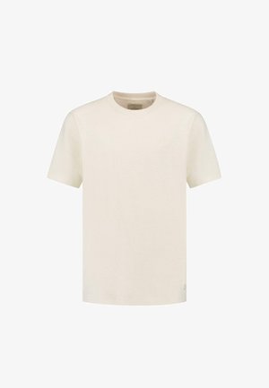 Világos bézs pamut póló kerek nyakkal, rövid ujjakkal és diszkrét logó részlettel. Sima textúra, klasszikus fazon és egyszerű dizájn.