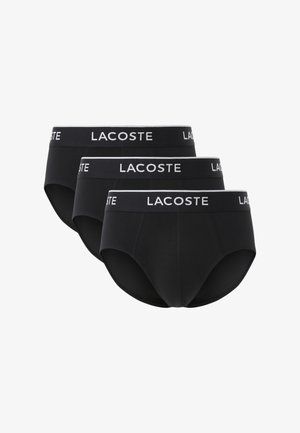 Mustat puuvillaiset alushousut, joissa on kontrastiväri valkoinen Lacoste-logon vyötärönauha. Ominaisuuksiin kuuluu istuva muotoilu ja sileä pinta, jotka soveltuvat päivittäiseen käyttöön.