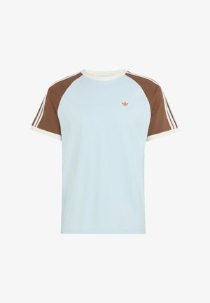 Light blue T-shirt with brown raglan sleeves, white collar and cuffs, featuring small brown Adidas trefoil logo on the chest.