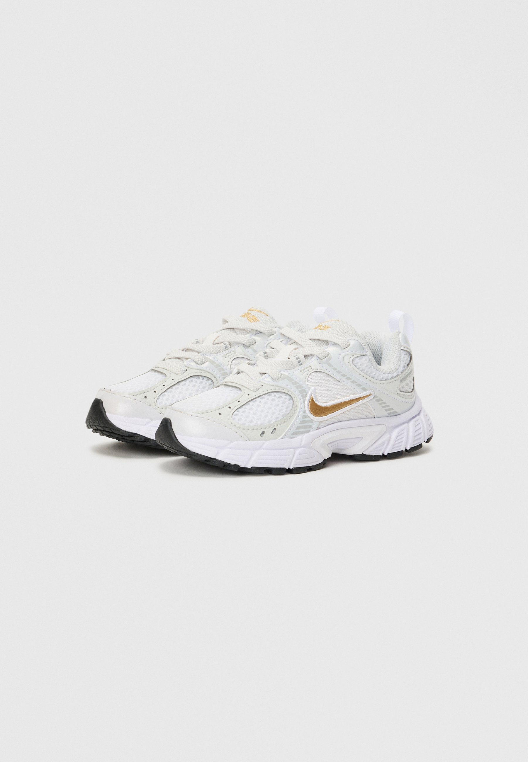 gold and white nike sneakers