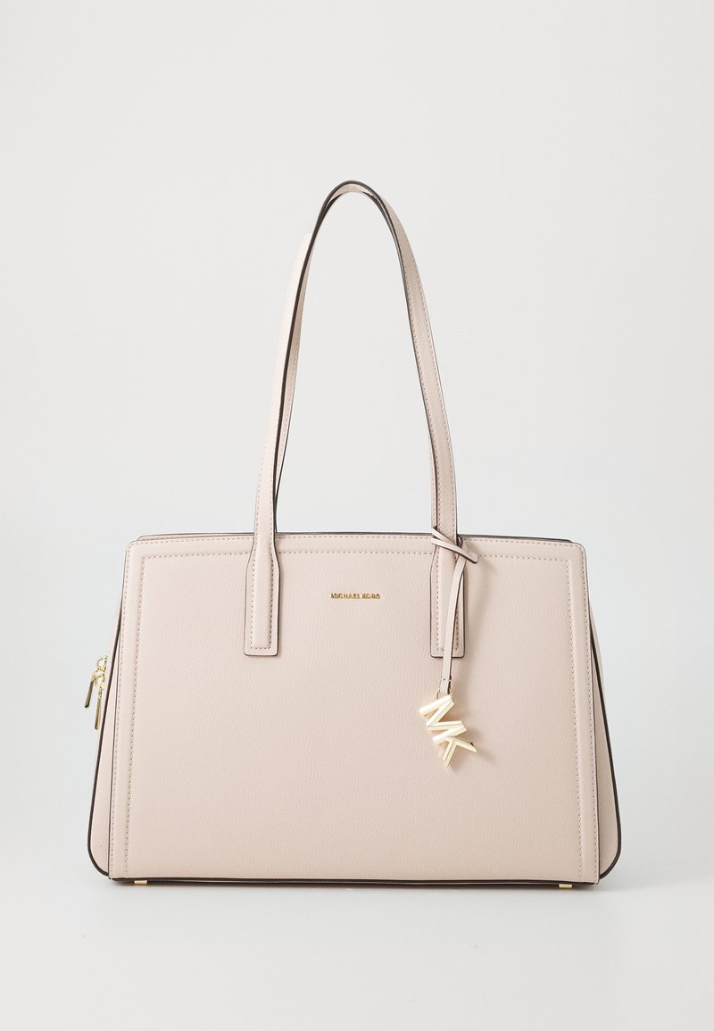 Light pink leather tote bag with a structured design, dual handles, gold-tone hardware, and an attached charm featuring "MK" initials.