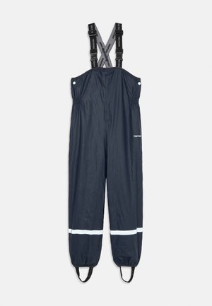 Salopettes imperméables de couleur marine avec bretelles noires réglables, taille élastique et bande réfléchissante blanche sur les jambes. Fabriquées à partir d'un matériau brillant et durable.