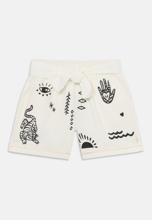 Shorts blancs en coton, ornés d'impressions graphiques noires incluant un tigre, des mains, un soleil et diverses formes géométriques. Taille ajustable.