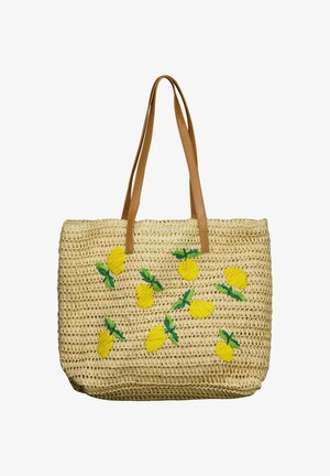 Sac fourre-tout tressé beige avec des anses en cuir marron, décoré de citrons jaunes brodés et de feuilles vertes.