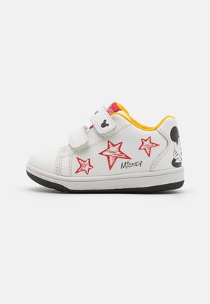 Zapatillas blancas con gráficos de estrellas rojas y diseño de Mickey Mouse, con dos correas de velcro y un interior amarillo. Suela de goma para mayor agarre.