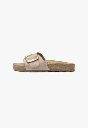 Beige suede slide sandal with a wide strap, featuring a gold square buckle and a textured cork footbed, set on a thick rubber sole.