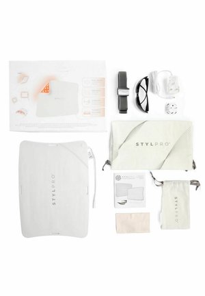 STYLPRO LED mask kit with mask, instruction sheet, strap, glasses, charger, power plug, pouches, cleaning cloth, and manual, all laid out neatly.