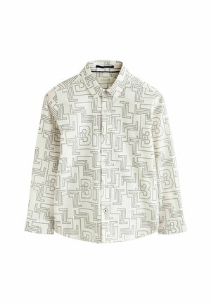 Camisa blanca de manga larga con un patrón geométrico negro. Cuenta con un collar puntiagudo y cierre de botones, fabricada en un tejido ligero.