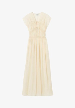 Lungo vestito color crema con maniche corte, vita raccolta, dettagli con fiocchi sul petto e gonna fluente.