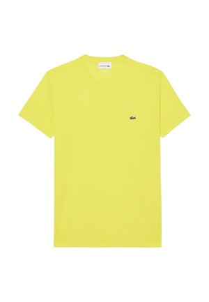 T-shirt giallo brillante a maniche corte realizzato in cotone. Presenta un collo rotondo e un piccolo logo di coccodrillo verde scuro sul petto.