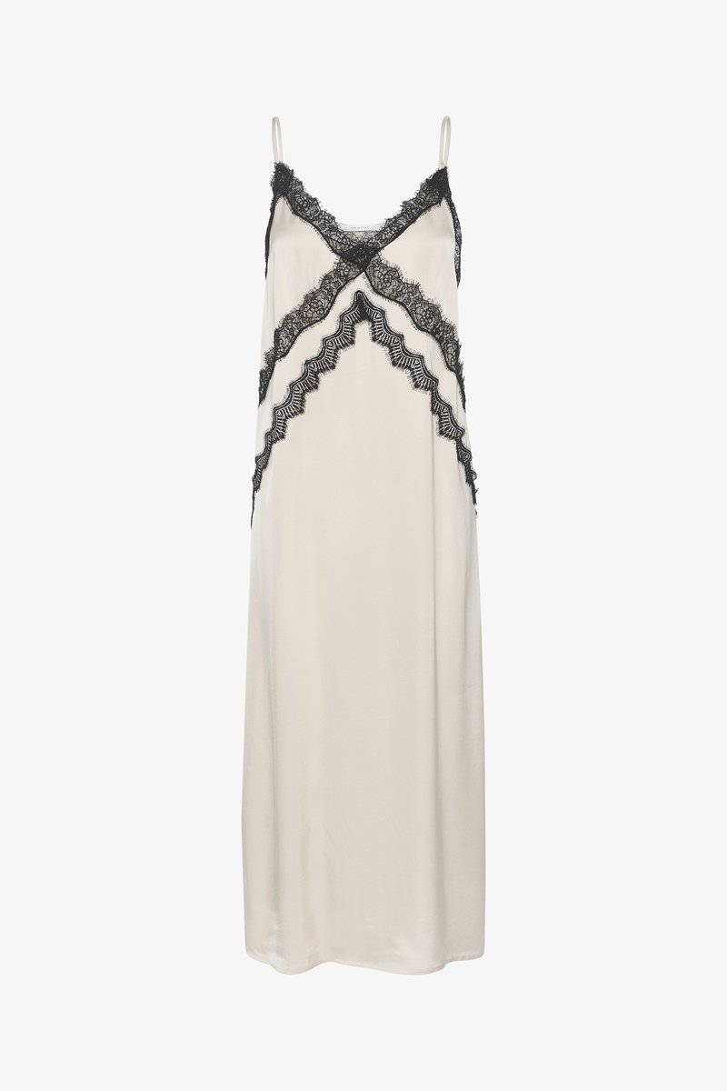 Vestido de seda en crema con acentos de encaje negro. Presenta tirantes delicados y una silueta fluida con detalles de encaje estampado.