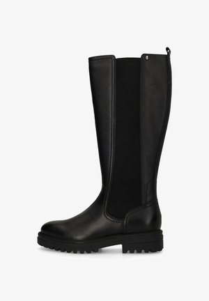 Black knee-high boot featuring smooth leather and elastic side panels, rugged sole, round toe, and a subtle metallic accent at the top.