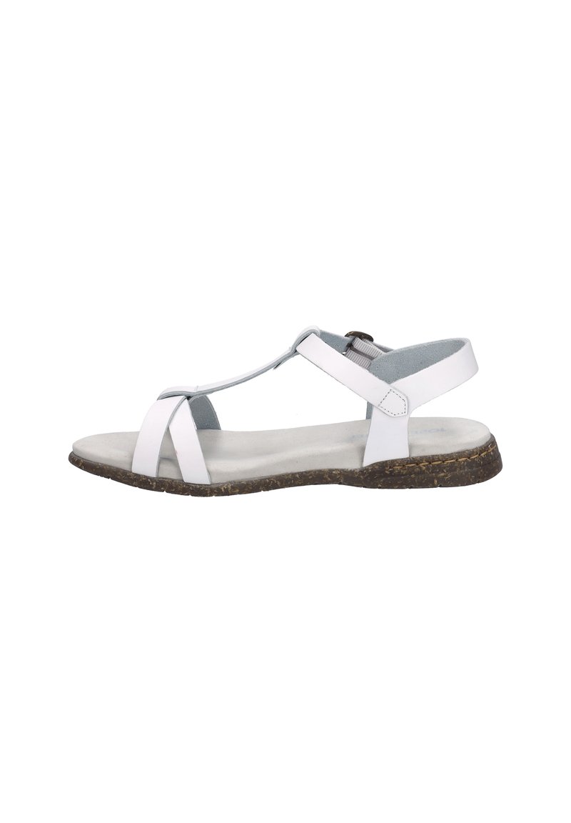 White leather sandal with T-strap design, adjustable ankle strap, flat cork sole, and soft textured footbed. Minimalist and open design.