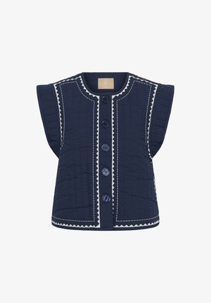 Oprta temnomodra prešita telovnik z širokimi odprtinami za roke, z belo cikcak šivom in šestimi gumbi spredaj. Gladek otip, brez kapuce.