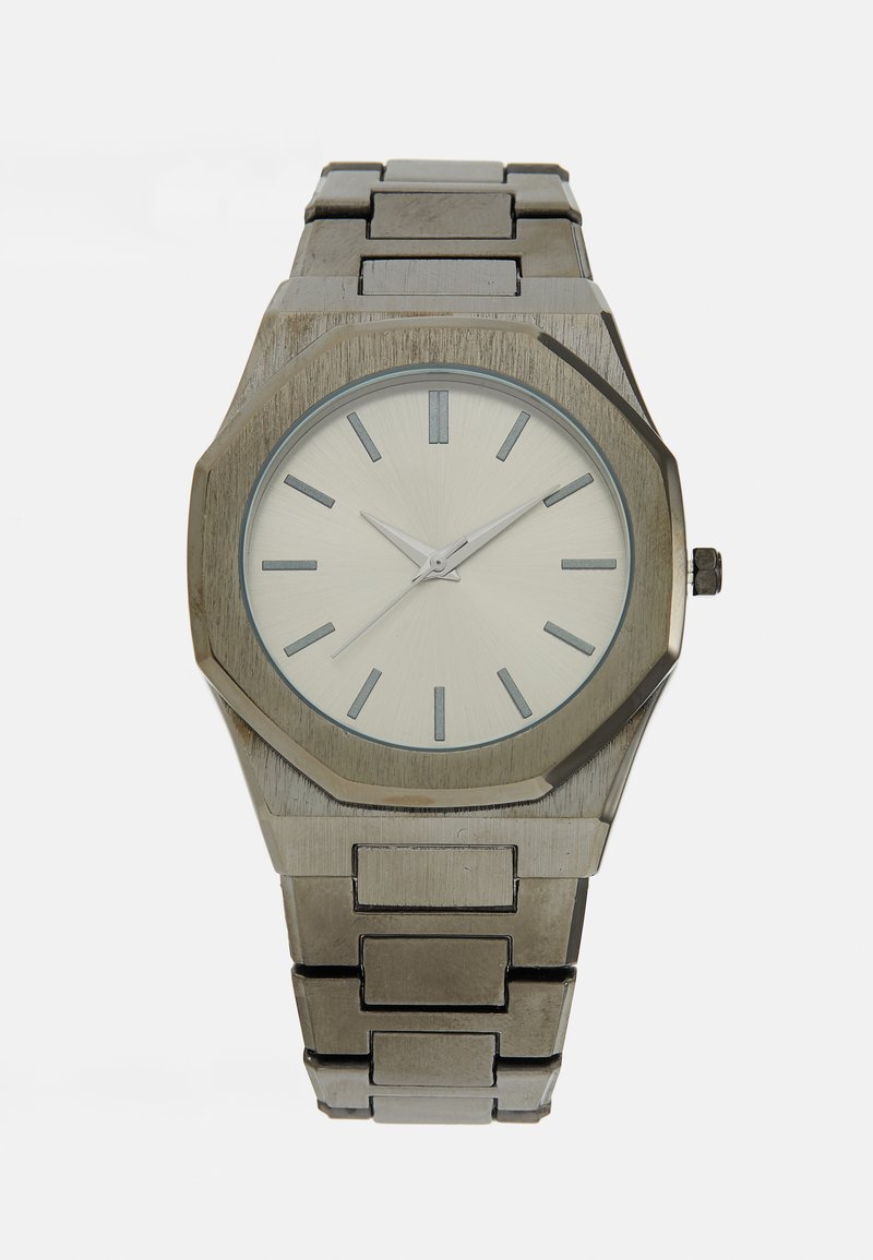 Metal watch with an octagonal silver case, light silver dial, silver hour markers, and a stainless steel bracelet.