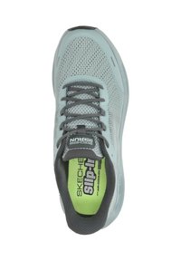 Light blue Skechers athletic shoe with gray laces, mesh upper, and green insole labeled "Slip-Ins" viewed from above.