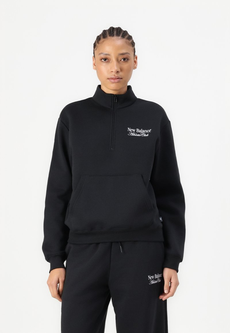 Svart fleece genser med halv glidelås, høy krage, kenguru-lomme, og hvit "New Balance Athlete Club" logo på brystet.