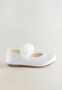 White satin ballet flat with round toe, featuring a fluffy white flower accent, beige interior, and a low tan rubber sole.