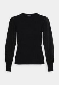 Svart stickad topp med ribbad struktur, rund halsringning och genomskinliga puffärmar. Har en figurnära passform och elastiska manschetter.