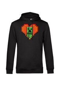Felpa nera con una figura verde pixelata all'interno di un cuore arancione. Presenta cordini e una tasca a marsupio. Tessuto morbido.