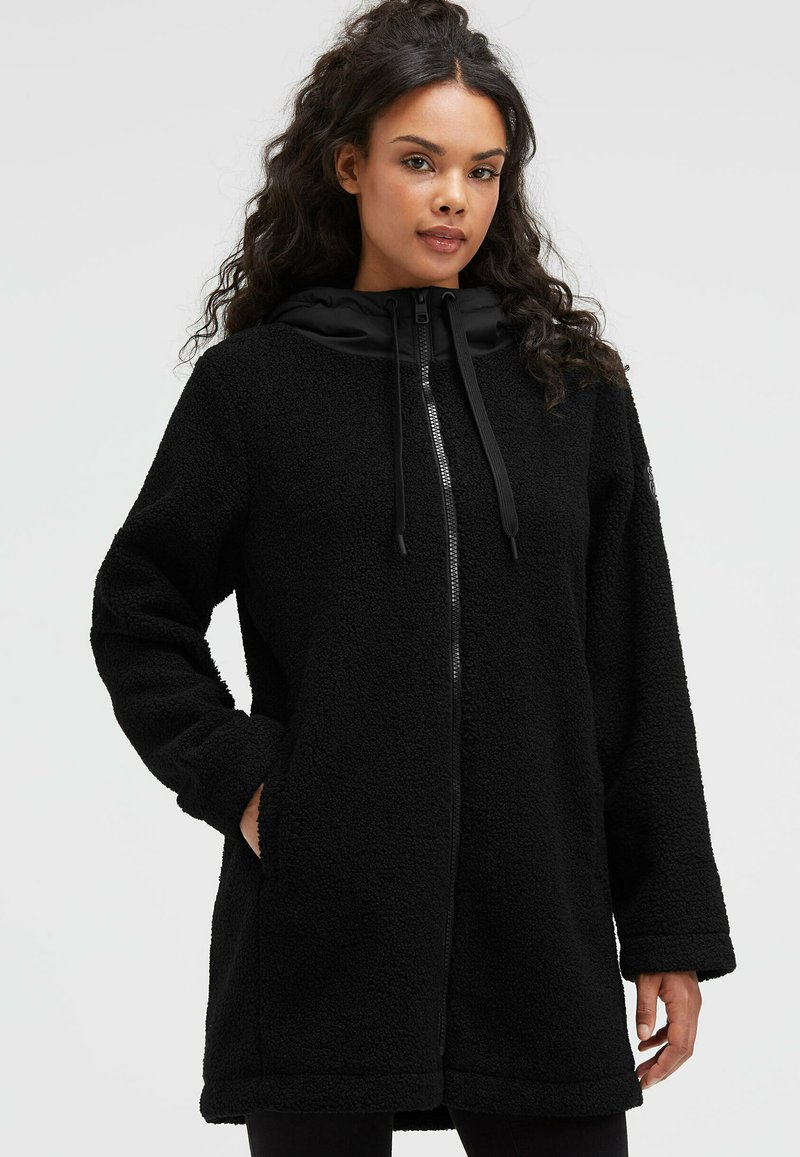 Black fleece jacket with a zip front, hood, and large pockets. Features a textured surface and a contrasting black smooth hood.