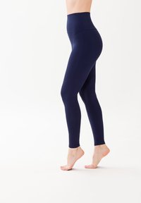 W fasonie wysokiego stanu, granatowe legginsy wykonane z elastycznego materiału, z gładką teksturą i dopasowanym krojem, który podkreśla sylwetkę.