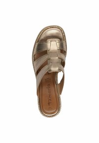 Metallisk gul slip-on sandal med tvärgående remmar, platt sula och texturerad trim, med en dämpad innersula för komfort.