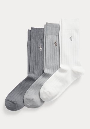 Three pairs of ribbed socks: dark gray, light gray, and white. Each pair features a small logo embroidered at the ankle.