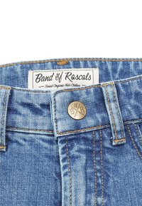 Close-up of blue denim children's jeans waistband with "Band of Rascals" label and branded metal button on front.