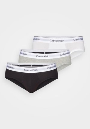 Calvin Klein brief set featuring three pairs: black, gray, and white. Soft cotton material, elastic waistbands with logo detail.
