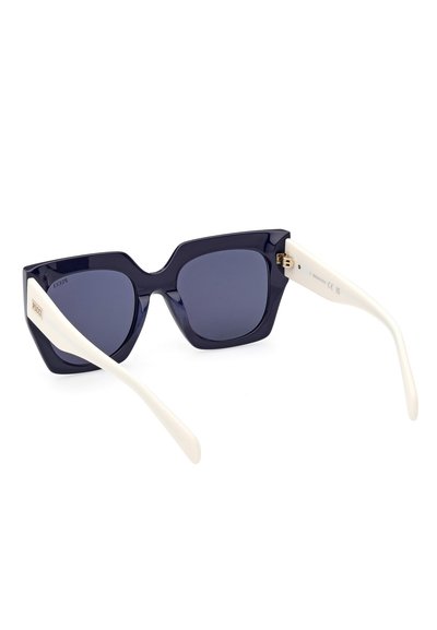 Cat-eye sunglasses with dark blue lenses, thick navy plastic frames, and white temples featuring gold hardware detailing.