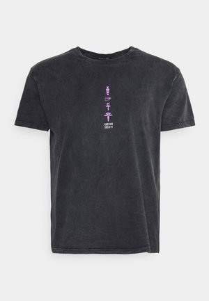 T-shirt nera a maniche corte con texture sbiadita, caratterizzata da piccoli simboli egiziani verticali viola e dalla scritta bianca "KAOTIKO SOCIETY" sul petto.