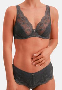 Dark gray lace bra with a V-neckline, floral pattern, and center embellishment. Matching lace panties feature a scalloped edge.