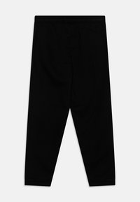 Black leggings made of a smooth, stretchy fabric. They feature an elastic waistband and tapered ankles with no visible patterns or embellishments.