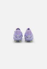 Purple soccer cleats with textured mesh upper, patterned accents, and translucent green studs. Features a pull tab at the heel for easy wear.