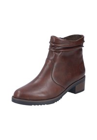 Botte de cheville en cuir marron avec un haut loose, des coutures subtiles, un petit talon carré et une semelle texturée pour une bonne adhérence.