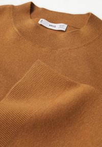 Brązowy sweter dzianinowy z prążkowanym okrągłym dekoltem i teksturowanym wzorem na rękawach. Metka z napisem "MNG" oraz instrukcje dotyczące pielęgnacji.