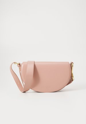 Pink leather crossbody bag with a rounded shape, gold hardware, and a long strap. Smooth texture with a subtle brand logo embossed.
