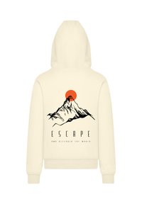 Helles Hoodie in Cremefarbe mit einem schwarzen Berggrafik, einem roten Sonnenaufgang und dem Text: "FLIEH UND ENTFESSEL DIE WELT" darunter. Weicher, lässiger Stoff.