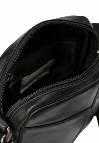 Borsa a tracolla in pelle nera con chiusura a zip, tasca interna e texture liscia. Presenta cuciture robuste e una cerniera metallica.