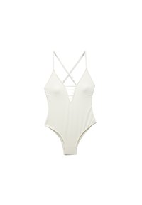 Maillot de bain une pièce blanc avec des bretelles croisées, décolleté en V profond, texture côtelée et jambes échancrées. Présente un détail à lacet à l'avant.