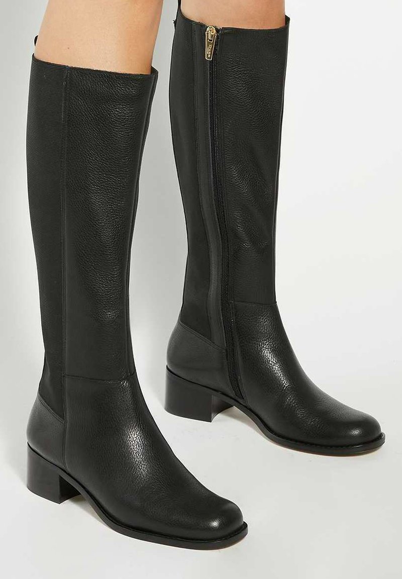 Black leather knee-high boots with a smooth texture, square toe, and a side zipper. Block heel provides stability. Simple design with no patterns.