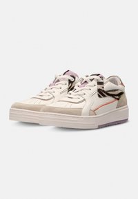 White sneakers with textured leather, suede accents in beige and orange, and a patterned panel in black, gray, and pink. Flat rubber sole.